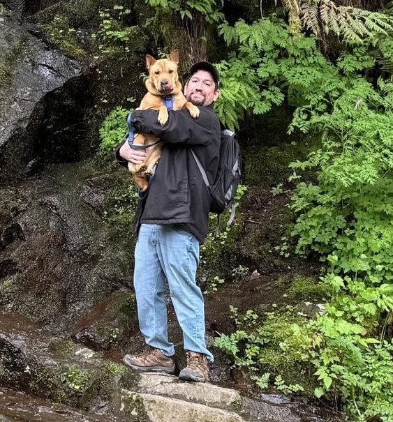 Anthony holding Ellie at a forest trail