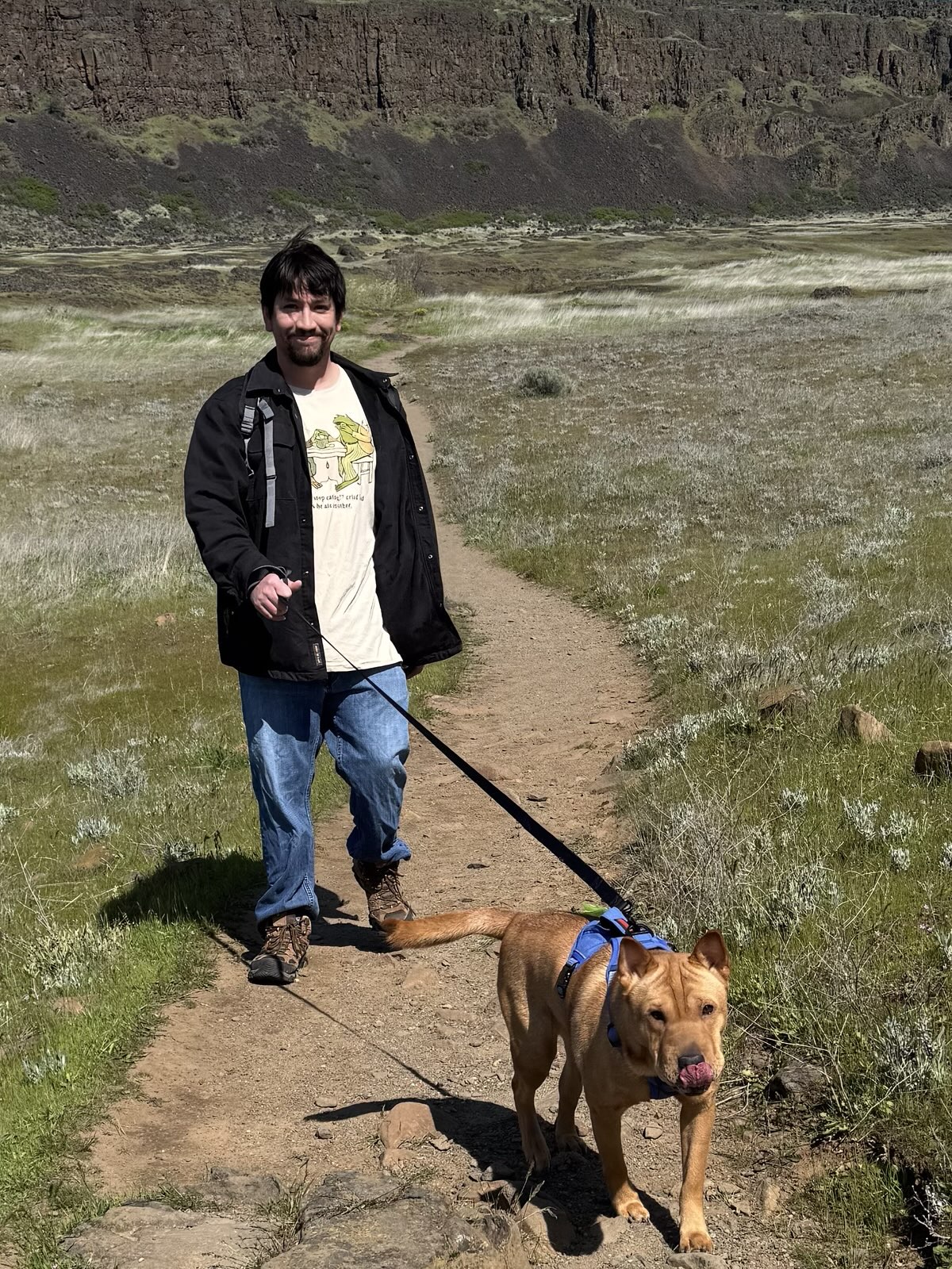 Anthony walking Ellie on a trail